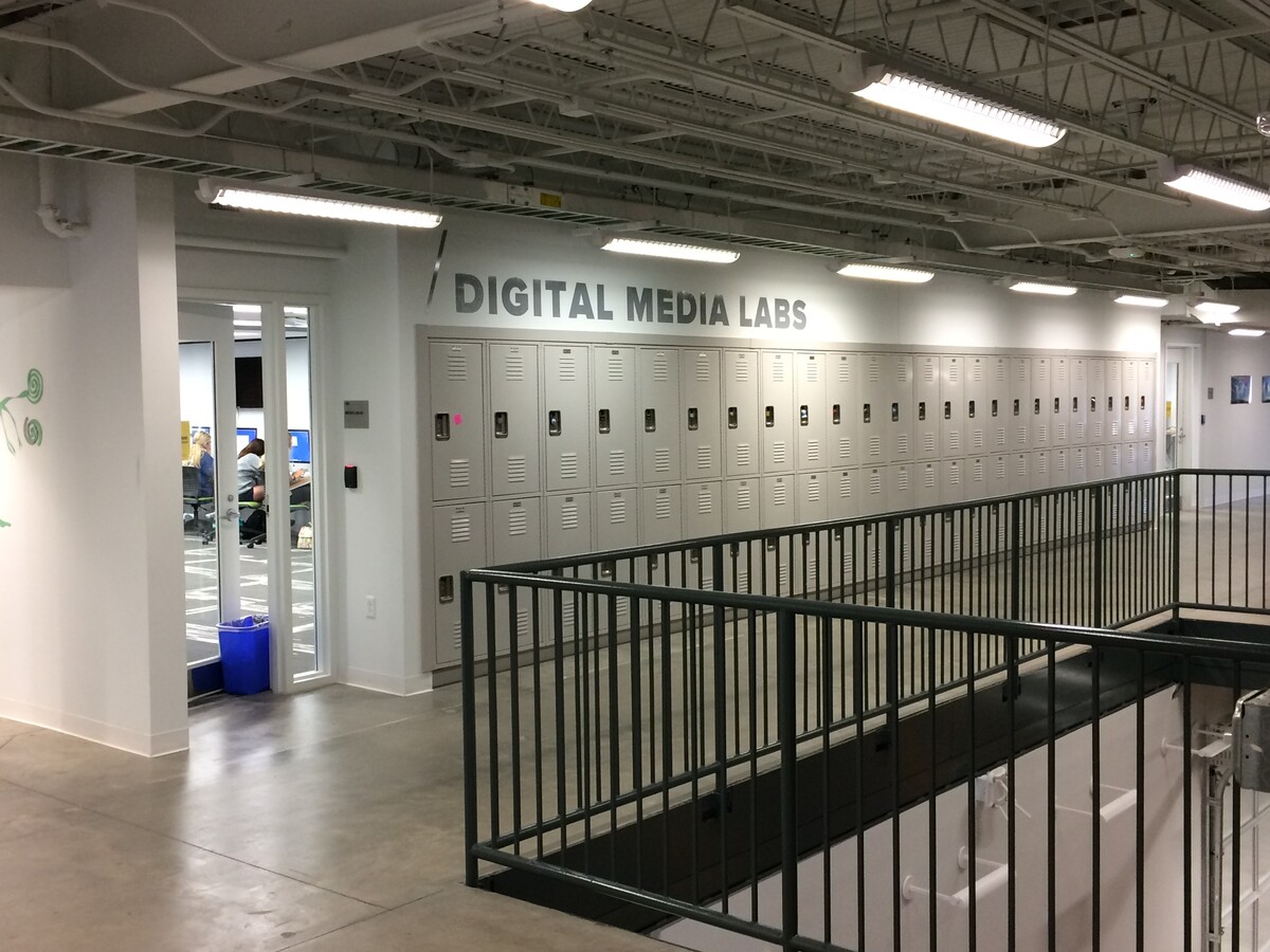The entrance to one of the second floor labs is available by a wall of lockers along a balcony.