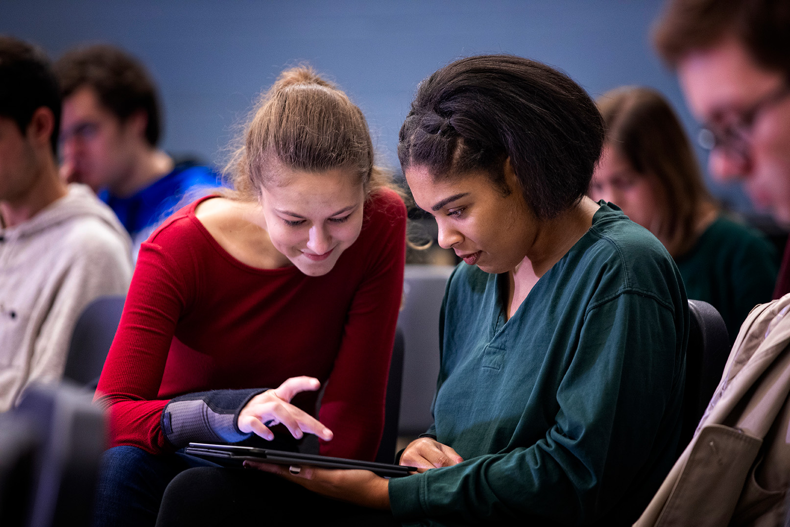 two students looking at ipad