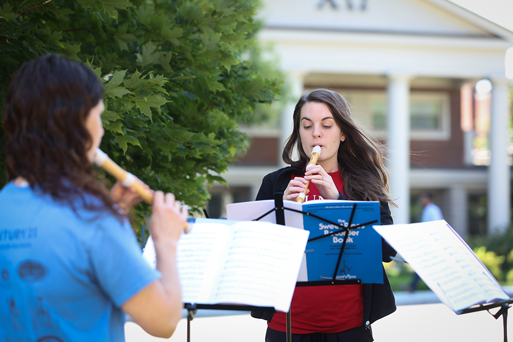 people playing recorders outside
