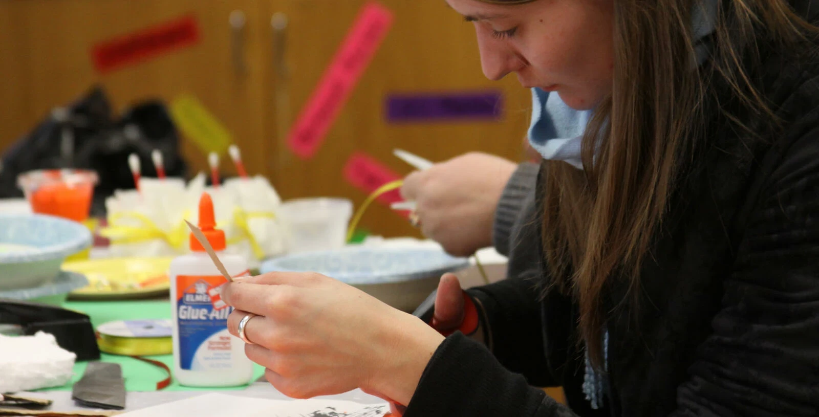 students cutting paper for art class