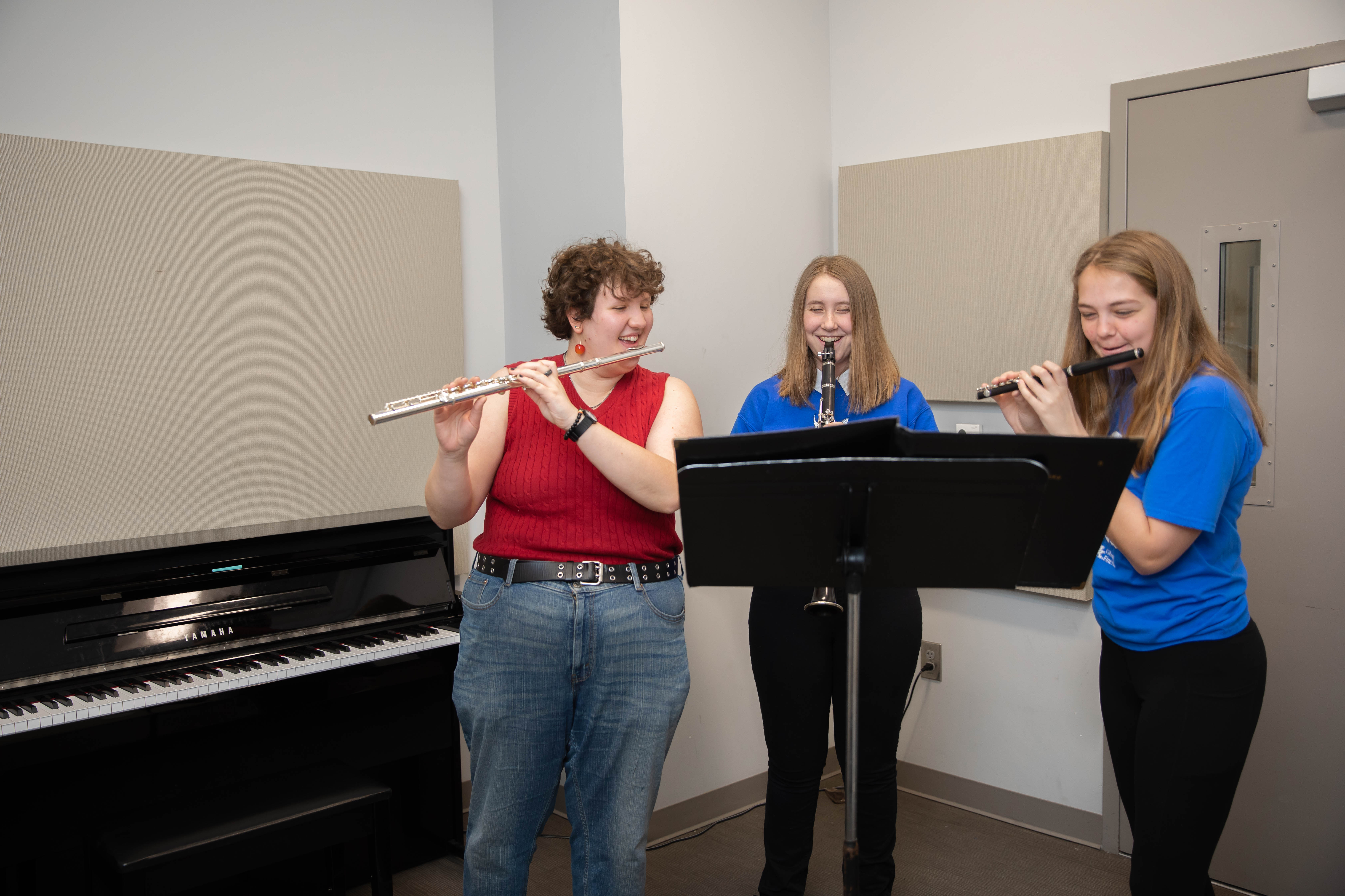 students playing flute with piano in background