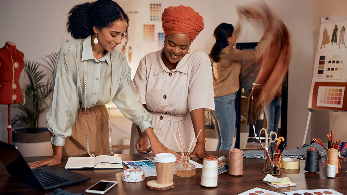people standing over table smiling