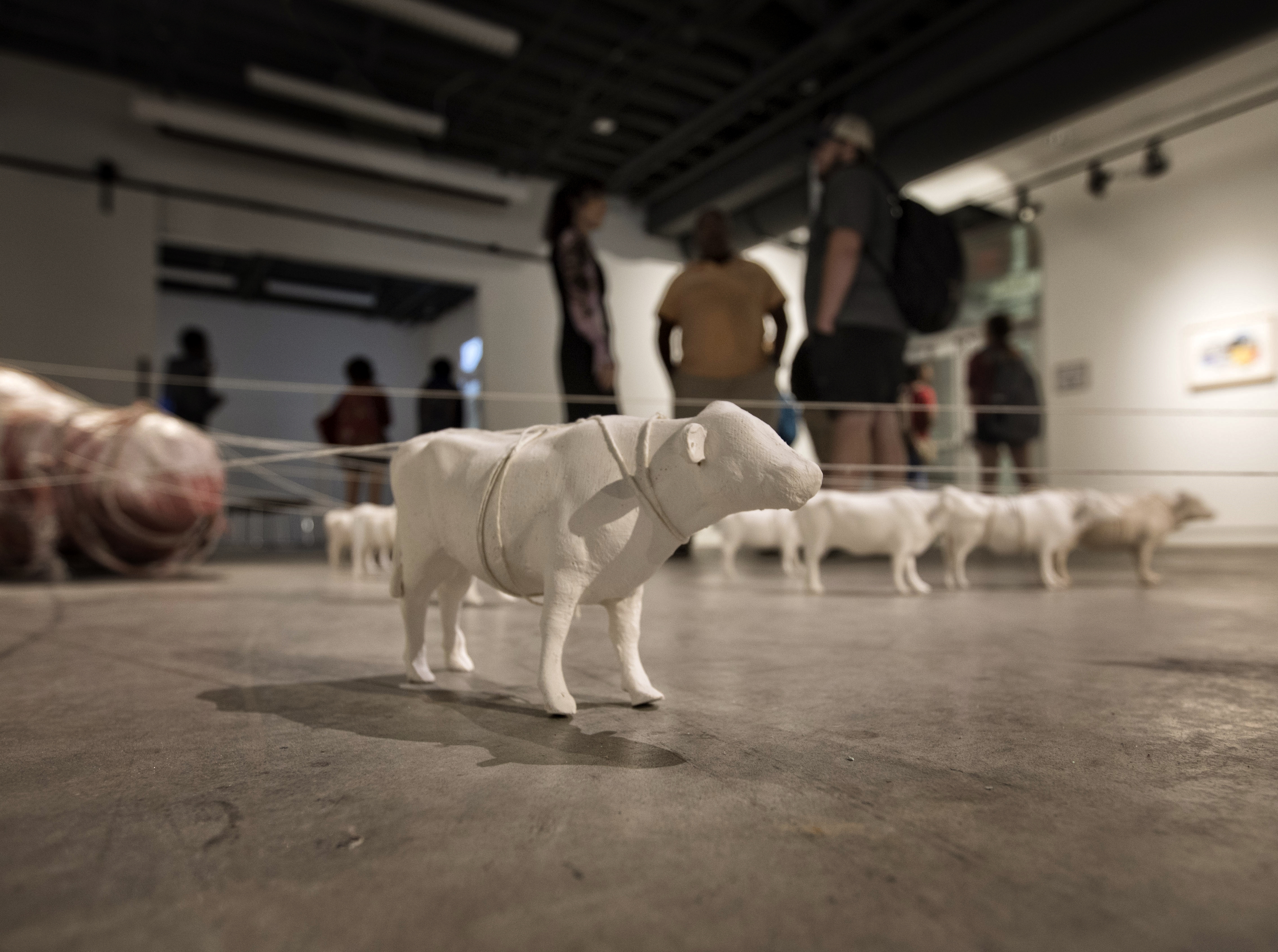 art sculpture of farm animals on floor of gallery