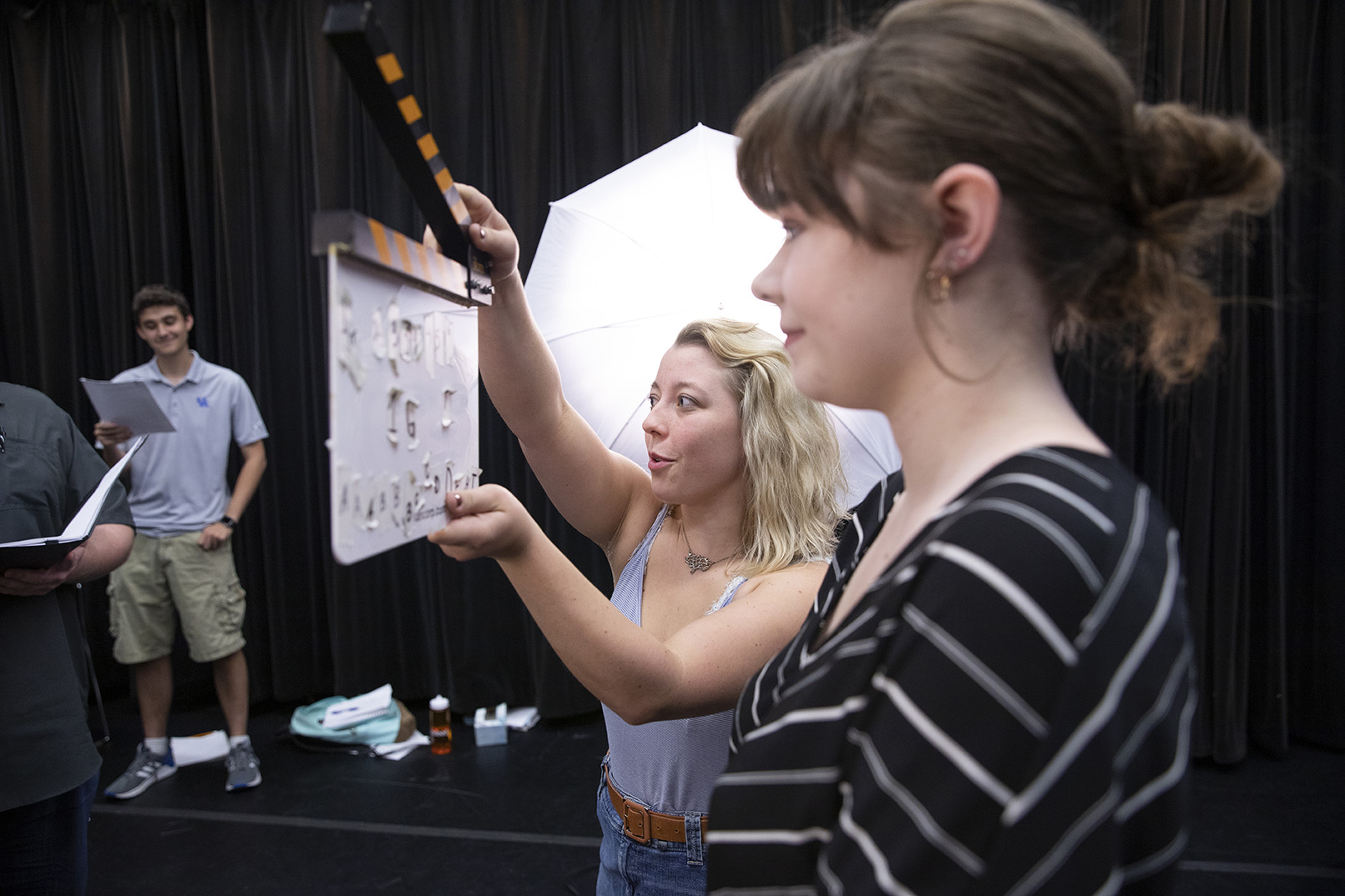 two students in film studio with clicker