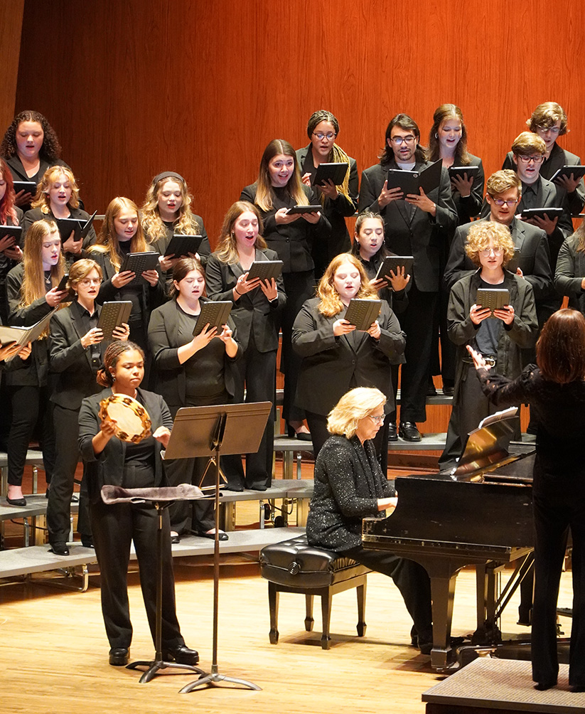 Singers on stage with piano accompanist in foreground