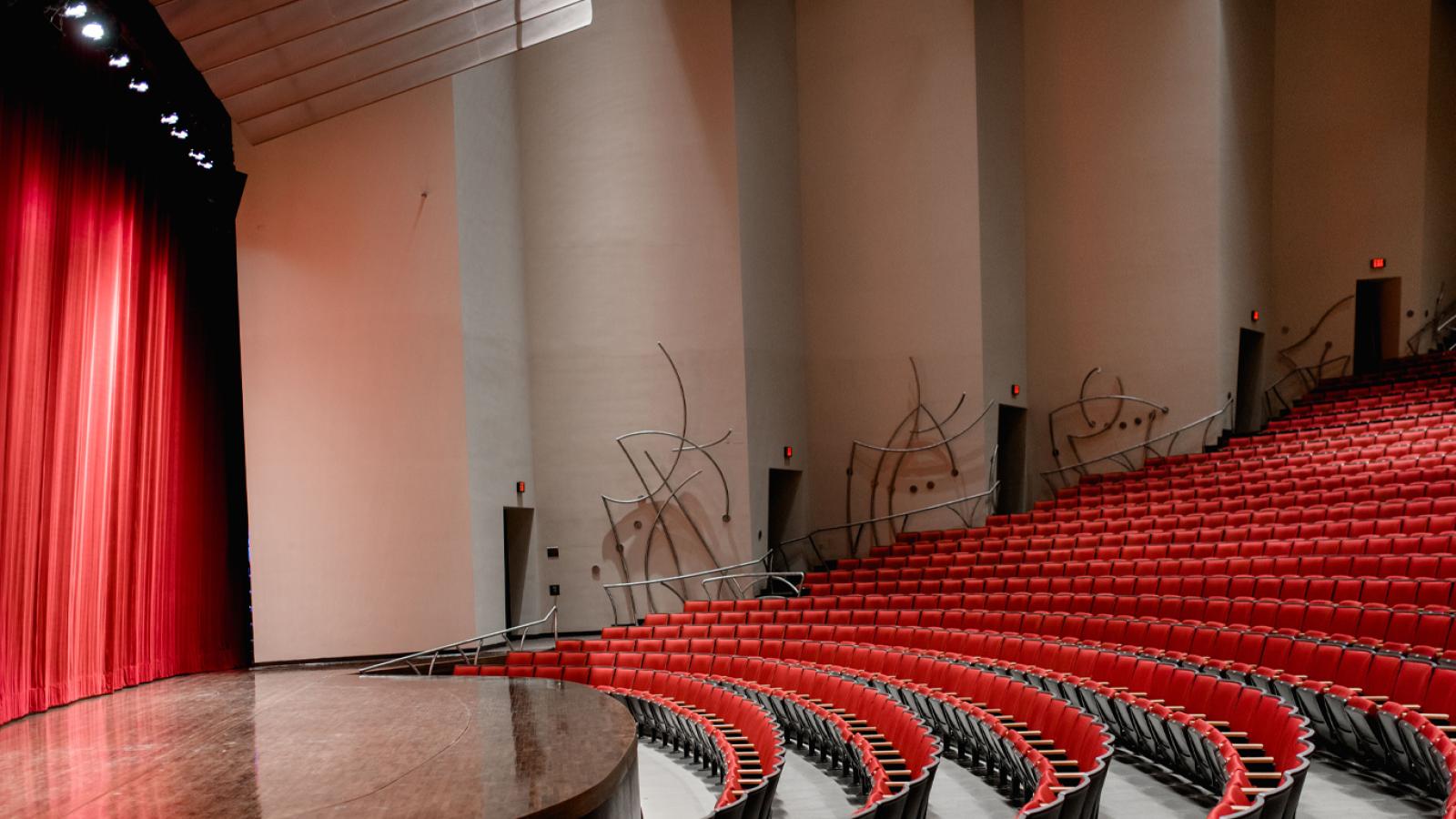 Stage right view of the stage and front rows of seats in the Concert Hall at the Singletary Center.