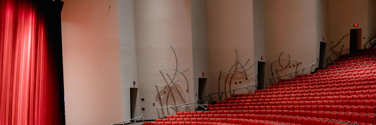 Stage right view of the stage and front rows of seats in the Concert Hall at the Singletary Center.