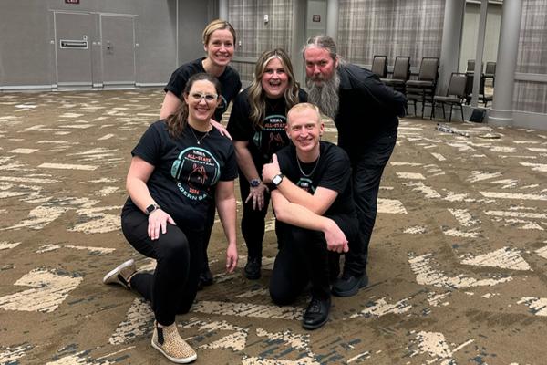 Clockwise, from back left: Martina Vasil, Taylor Ayotte, Austin Robinson, David Dockan and Kailey Holmes. This group of educators helped coordinate the first all-state elementary modern band performance at the '24 KMEA conference. Photo provided.