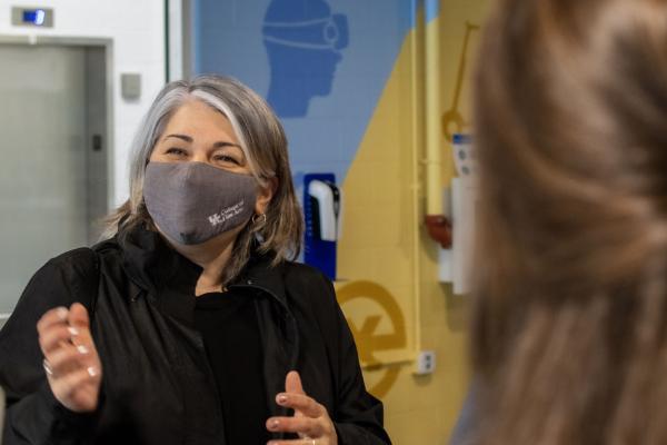 Person in mask gesturing