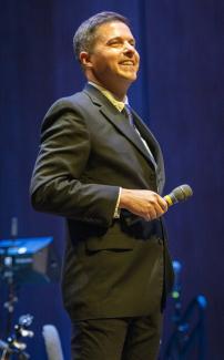 Matthew Gibson holding a microphone