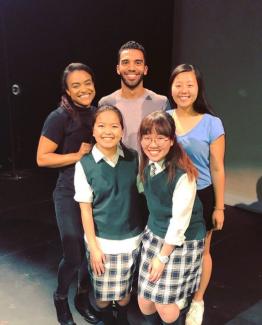 Five people in costume smiling at camera
