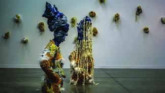 sculptures of two women in gallery