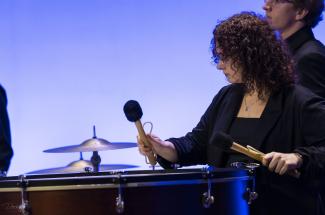 student playing drum on stage
