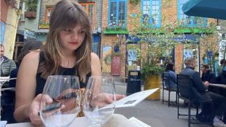 image of Meg Klosterman at a cafe in Paris