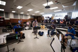 masked student musicians physically distanced in classroom