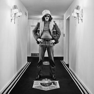 person in hallway in hat black and white photography