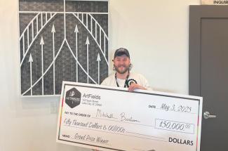 Mitchell Burleson holds giant check