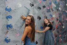 dancers smiling at mural in berlin