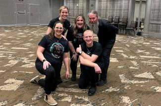 Clockwise, from back left: Martina Vasil, Taylor Ayotte, Austin Robinson, David Dockan and Kailey Holmes. This group of educators helped coordinate the first all-state elementary modern band performance at the '24 KMEA conference. Photo provided.
