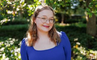 Elizabeth Watson in front of trees