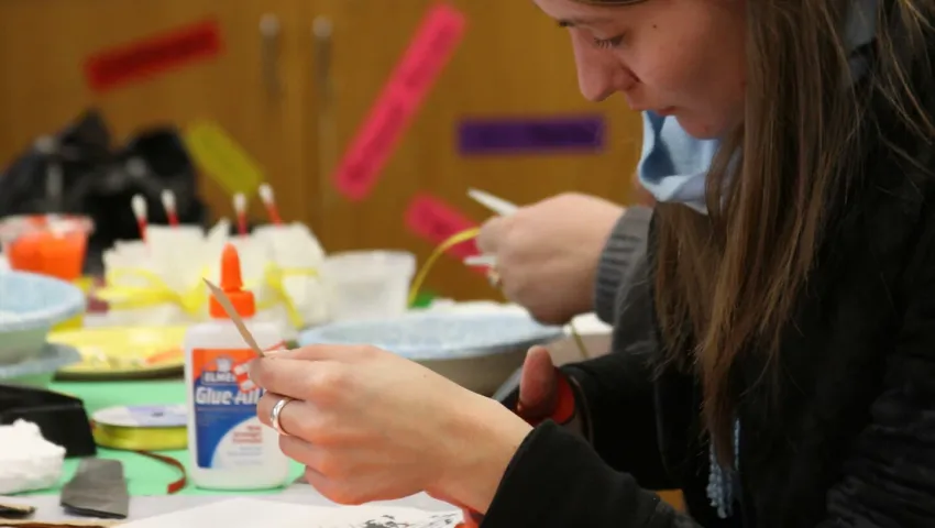 students cutting paper for art class