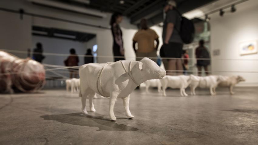 art sculpture of farm animals on floor of gallery