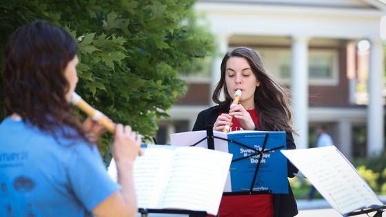 people playing recorders outside