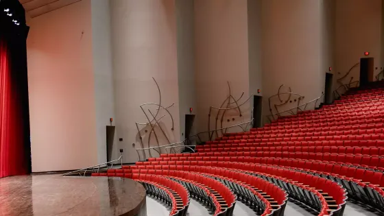 singletary center house seats and partial stage view with red curtain