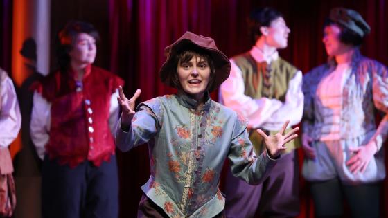 student on stage in shakespearean costume