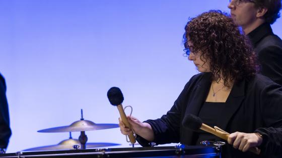 student playing drum on stage