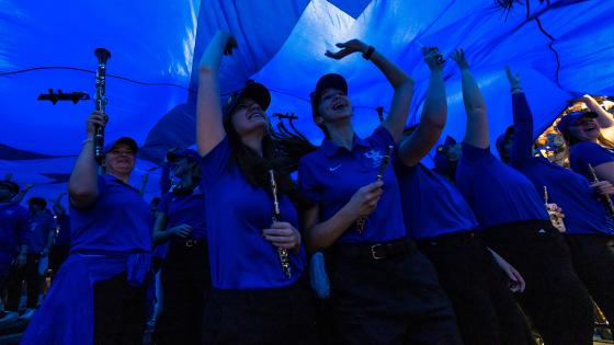 student musicians under tarp at UK basketball game