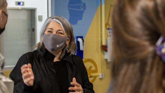 Person in mask gesturing