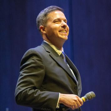 Matthew Gibson holding a microphone