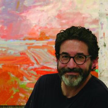 Patrick Adams in front of colorful painting