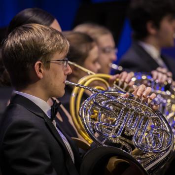 person playing french horn