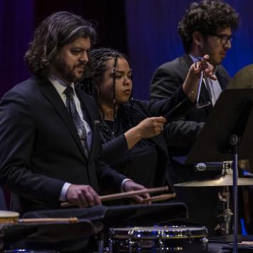students playing percussion instruments on stage