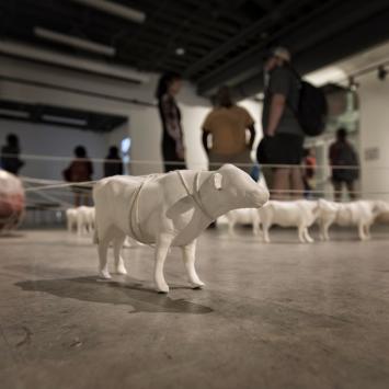 art sculpture of farm animals on floor of gallery
