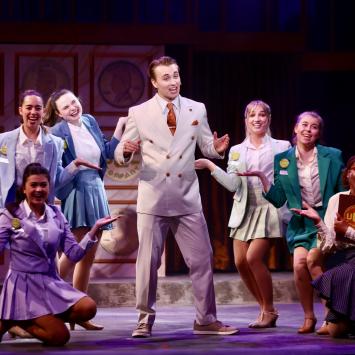 students singing in group on stage