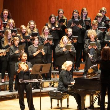 Singers on stage with piano accompanist in foreground