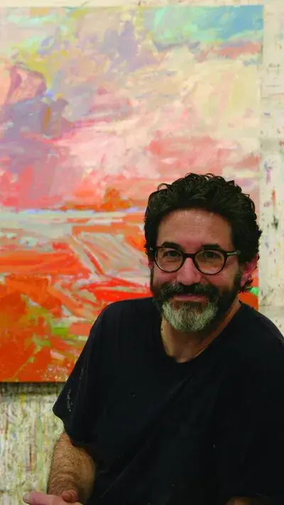 Patrick Adams in front of colorful painting